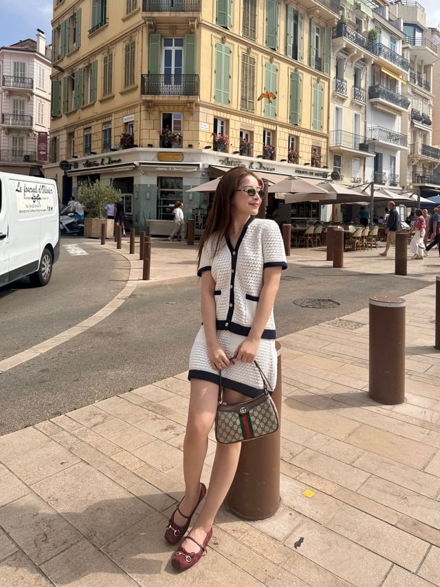 Chi tiết giày ballet màu đỏ nâu đóng vai trò hoàn thiện tổng thể, tạo điểm nhấn dịu dàng mà vẫn cuốn hút